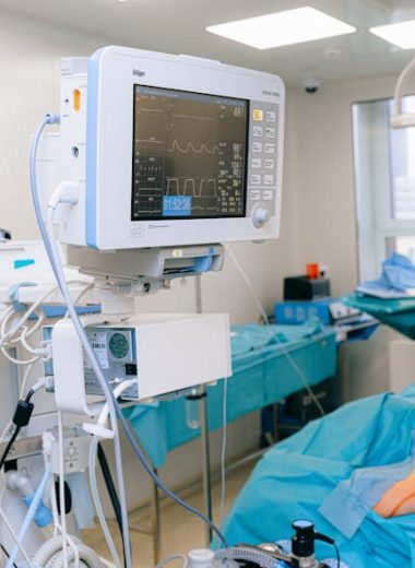 Close-up of vital signs monitor in a modern operating room setup.